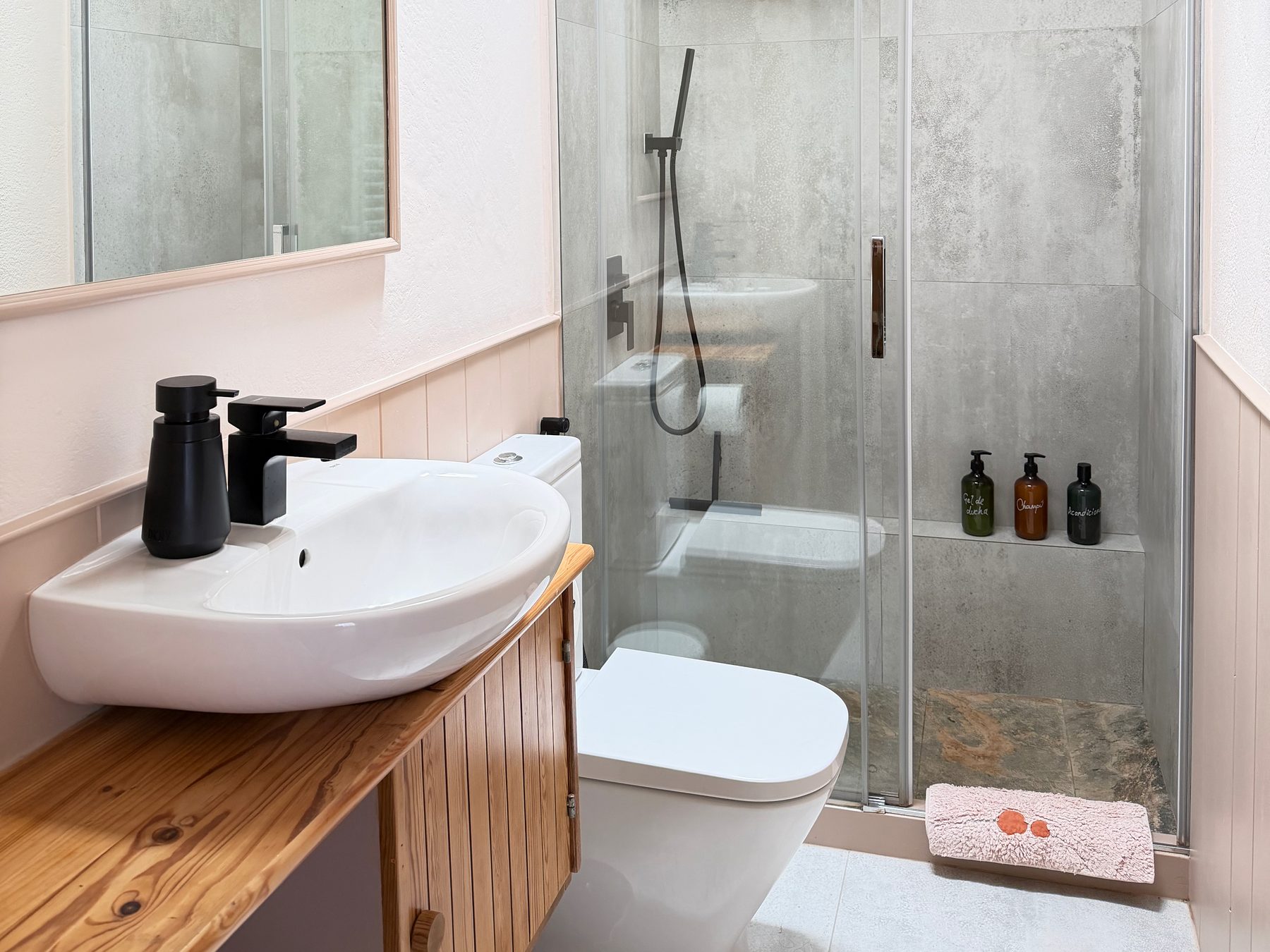 The bathroom — the restored 1970s vanity and the walk-in shower